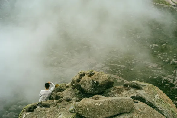 Women seating on a cliff